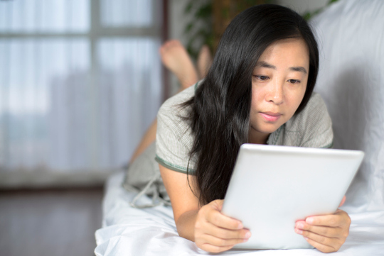 woman reading from tablet